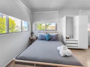 a bedroom with a large bed with a teddy bear on it at Aquabella 6 Tropical Escape in Isla Verde in San Juan