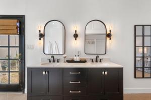 a bathroom with two sinks and two mirrors at Walk To Dt Phx Convention Center Historic in Phoenix +38 photos