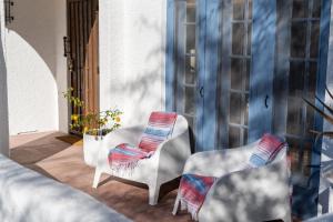 a couple of chairs sitting on a porch at Walk To Dt Phx Convention Center Historic in Phoenix