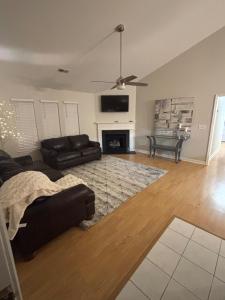 a living room with a couch and a fireplace at South Charlotte home in Charlotte