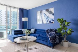 a blue living room with a blue couch and a table at Oceanview King Bed Right on the Beach w Pool&Gym in Hollywood