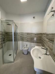 a bathroom with a sink and a shower and a toilet at Appartamento Angolo Blu Fronte Mare in Gallipoli
