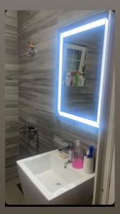 a bathroom with a white sink and a mirror at Villa Roni in Peje
