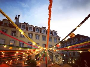 a large building with christmas lights in front of it at Arroios Concept Apartments by Homing in Lisbon