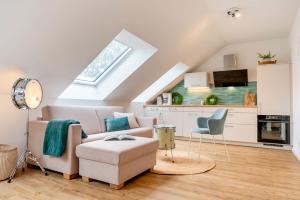 a living room with a couch and a chair at Ferienhof Taarstedt Mikkey in Taarstedt