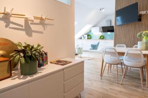 a kitchen with white chairs and a dining room at Ferienhof Taarstedt Mikkey in Taarstedt