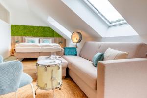 a living room with a couch and a bed at Ferienhof Taarstedt Mikkey in Taarstedt