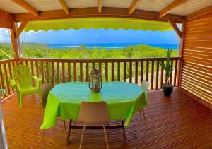 a table on a deck with a view of the ocean at Villa spacieuse à Saint-François avec piscine privée in Saint-François