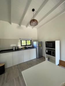a large kitchen with white cabinets and a window at Anna Apart Boutique in Colón +29 photos