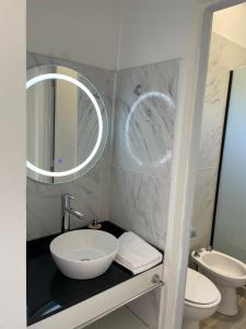 a bathroom with a sink and a toilet and a mirror at Anna Apart Boutique in Colón