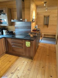 a kitchen with wooden floors and a counter top at Merveilleux chalet à la montagne in La Colmiane +11 photos