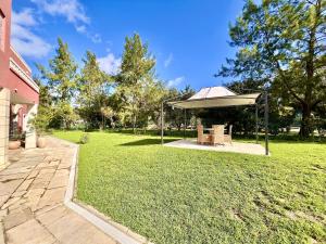 a gazebo with a table and chairs in a yard at Loulé Stylish 1 with Pool by Homing in Loulé