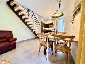 a dining room with a table and chairs and a staircase at Loulé Stylish 1 with Pool by Homing in Loulé
