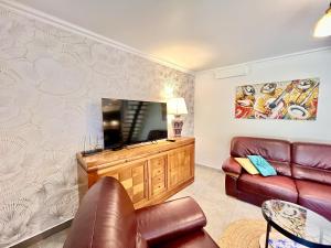 a living room with a couch and a television at Loulé Stylish 1 with Pool by Homing in Loulé