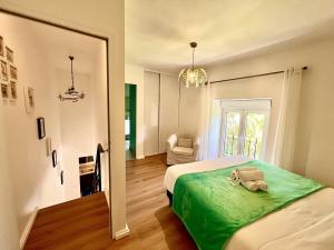 a bedroom with a bed with a green blanket at Loulé Stylish 1 with Pool by Homing in Loulé +27 photos