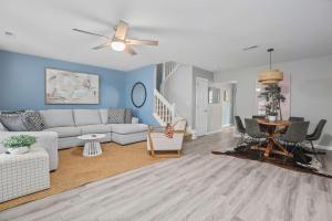 a living room with a couch and a table at Chucktown Charm- 8 mins to Credit One in Charleston