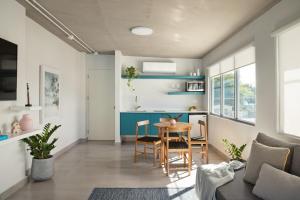 a kitchen and living room with a table and chairs at Aquabella 7 Paradise Stay in Isla Verde in San Juan