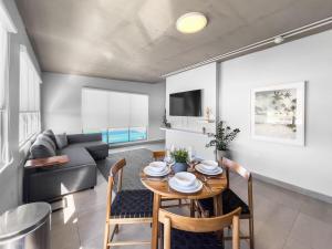 a dining room and living room with a table and chairs at Aquabella 7 Paradise Stay in Isla Verde in San Juan