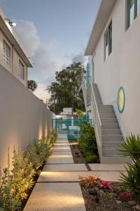 a walkway leading up to a building with stairs at Aquabella 7 Paradise Stay in Isla Verde in San Juan