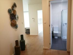 a room with a toilet and plates on the wall at Azores Paim Apartment T2 in Ponta Delgada +9 photos