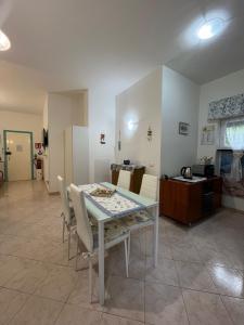 a dining room with a white table and chairs at La Conchiglia di Monterosso in Monterosso al Mare