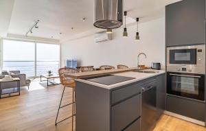 a kitchen and living room with a view of the ocean at Cozy Apartment In Benalmadena With Wifi in Benalmádena