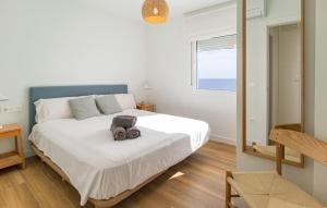 a bedroom with a bed with a camera on it at Cozy Apartment In Benalmadena With Wifi in Benalmádena