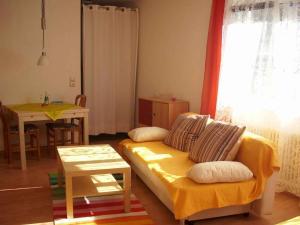 ein Wohnzimmer mit einem Sofa und einem Tisch in der Unterkunft Ferienwohnung zur Schauinslandbahn in Horben