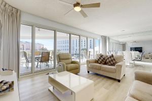 a living room with a couch and chairs and a balcony at TOPS'L Tides 0207 in Destin