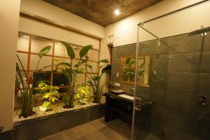 a bathroom with a shower and a fish tank at Arvita Villa with Swimming Pool in Rāma +11 photos