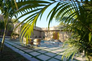 a patio with a table and chairs next to a house at Arvita Villa with Swimming Pool in Rāma
