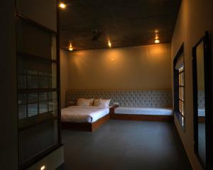 a bedroom with a bed in the corner of a room at Arvita Villa with Swimming Pool in Rāma