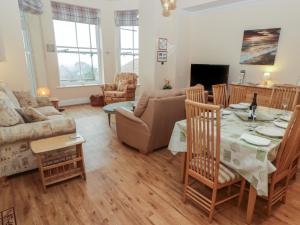 a living room with a table and a couch at Apartment 7 Mansion House in Tenby