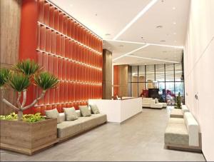 an office lobby with a couch and a desk at FP Suites The Shore Kota Kinabalu in Kota Kinabalu +6 photos