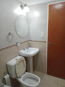 a bathroom with a toilet and a sink and a mirror at Centro de Paraná - 1 Dormitorio !!! in Paraná