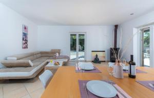a living room with a couch and a table at Villa Mali Raj in Žikovići