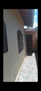 a corner of a building with a gate and a door at Casa de praia Mongaguá in Mongaguá