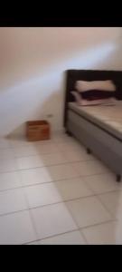 a bedroom with a bed and a tiled floor at Casa de praia Mongaguá in Mongaguá