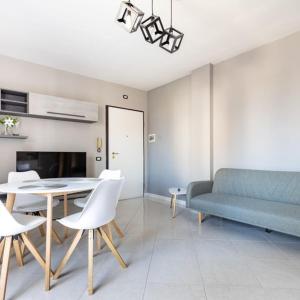 a living room with a couch and a table and chairs at Casa Libeccio in Quartu SantʼElena