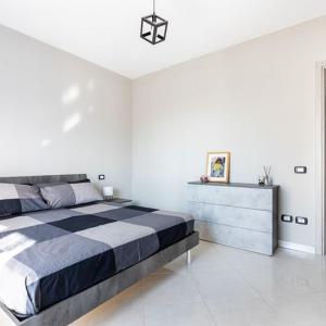 a bedroom with a large bed in a white room at Casa Libeccio in Quartu SantʼElena