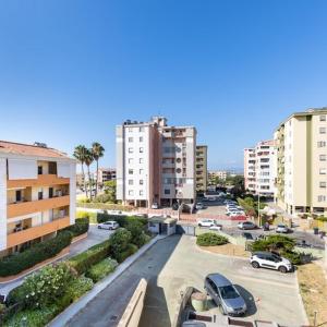a city street with cars parked in a parking lot at Casa Libeccio in Quartu SantʼElena