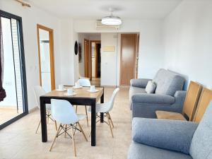 a living room with a table and a couch at ACV- Terrazas II-2ª linea planta 9 este in El Borseral