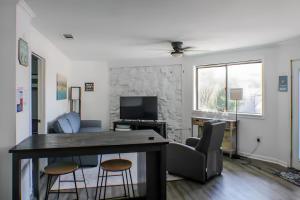 a living room with a table and two chairs at Peaceful Lydia Hide-O-Way - Unwind Near Beach, Breakfast, Spa & Go-Karts! in Panama City Beach