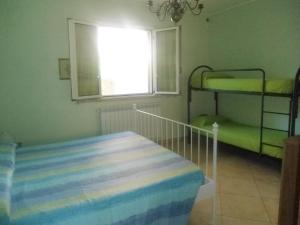 a bedroom with two bunk beds and a window at Appartamenti turistici di Gabriele 20 mt dal mare in Pineto