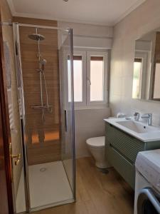 a bathroom with a shower and a toilet and a sink at Casa Noa in Serrapio