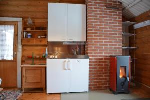 a kitchen with a white refrigerator and a stove at Ukonloma Aimola in Rovaniemi