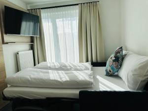 Voodi või voodid majutusasutuse Hotel Lainbach in Wängle toas