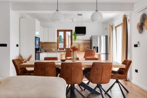 a kitchen and dining room with a table and chairs at Beautiful Villa Rustica with pool in Vrana