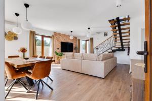 a dining room and living room with a table and chairs at Beautiful Villa Rustica with pool in Vrana