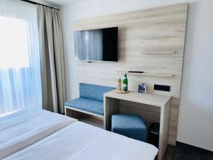 Voodi või voodid majutusasutuse Hotel Lainbach in Wängle toas